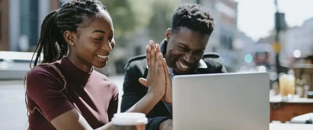 Students smiling and high fiving